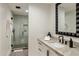 Modern bathroom with a large shower and a geometric vanity mirror at 11268 E Moonlight Cyn, Scottsdale, AZ 85255