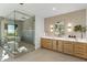 Bathroom featuring dual vanity, a walk-in shower, soaking tub, and mountain views at 11268 E Moonlight Cyn, Scottsdale, AZ 85255