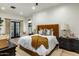 Bedroom featuring stylish furnishings, plush bedding, hardwood floors, and French doors to a patio at 11268 E Moonlight Cyn, Scottsdale, AZ 85255