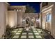 Beautiful courtyard with a stone archway, custom water feature, and lush landscaping at 11268 E Moonlight Cyn, Scottsdale, AZ 85255