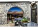 Elegant dining room features a stone archway with stunning city views at sunset at 11268 E Moonlight Cyn, Scottsdale, AZ 85255