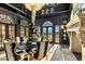 Grand dining room with black decor, custom chandelier, fireplace, and mountain views through arched windows at 11268 E Moonlight Cyn, Scottsdale, AZ 85255