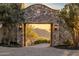 Stone archway frames the tranquil mountain view at the end of the paver driveway at 11268 E Moonlight Cyn, Scottsdale, AZ 85255