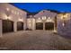 Impressive driveway leading to a spacious five-car garage with custom doors and exterior lighting at 11268 E Moonlight Cyn, Scottsdale, AZ 85255