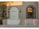 Inviting front entrance with lighted steps, stucco archway, decorative fountain and tiled accents at 11268 E Moonlight Cyn, Scottsdale, AZ 85255