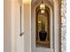 Arched hallway decorated with a tall plant in a black vase under lantern lighting at 11268 E Moonlight Cyn, Scottsdale, AZ 85255