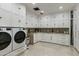 Bright laundry room with ample storage cabinets, modern appliances, and marble countertop at 11268 E Moonlight Cyn, Scottsdale, AZ 85255