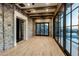 Open living room boasts a wall of windows, stone accent wall and rustic wood beams at 11268 E Moonlight Cyn, Scottsdale, AZ 85255