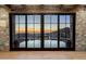 Stunning living room view through wall of glass to outdoor pool, lounge, and firepit with mountain view beyond at 11268 E Moonlight Cyn, Scottsdale, AZ 85255