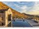 Stunning pool with mountain views, sun shelf, integrated spa, and desert landscaping create an oasis at 11268 E Moonlight Cyn, Scottsdale, AZ 85255