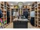 Spacious walk-in closet with custom shelving, drawers and center island for optimal storage at 11268 E Moonlight Cyn, Scottsdale, AZ 85255