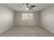 View of the spacious carpeted bedroom features a ceiling fan and bright window with shutters at 11430 E Neville Ave, Mesa, AZ 85209