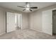 Carpeted bedroom with neutral colors, a ceiling fan, and ensuite bathroom and closet access at 11430 E Neville Ave, Mesa, AZ 85209