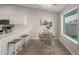 Bright dining area adjacent to the kitchen, featuring a modern chandelier and a large window at 11430 E Neville Ave, Mesa, AZ 85209