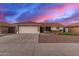 Charming single-story home with a tile roof, well-manicured desert landscaping, and an attached two-car garage at 11430 E Neville Ave, Mesa, AZ 85209