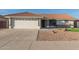 Attractive single-story home featuring desert landscaping, stone accents, and a two-car garage at 11430 E Neville Ave, Mesa, AZ 85209