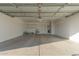 Spacious garage with epoxy floor, white walls, sink and storage shelving at 11430 E Neville Ave, Mesa, AZ 85209