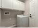 Bright laundry room featuring a white washer, upper cabinets, and neutral wall color at 11430 E Neville Ave, Mesa, AZ 85209