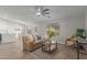 Bright living room with wood floors, neutral furniture, and a view of the backyard at 11430 E Neville Ave, Mesa, AZ 85209