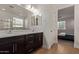 Bathroom features double sinks, dark wood cabinetry, and a tiled floor at 11744 S 173Rd Ln, Goodyear, AZ 85338