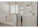 Bathroom with a soaking tub and a separate glass-enclosed shower at 11744 S 173Rd Ln, Goodyear, AZ 85338