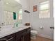 Bathroom featuring dark wood cabinets, white countertops, and stylish fixtures at 11744 S 173Rd Ln, Goodyear, AZ 85338