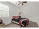 Bedroom features carpet, a ceiling fan, and a sliding door closet at 11744 S 173Rd Ln, Goodyear, AZ 85338