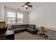 Bedroom with a ceiling fan, carpet, and a comfortable seating area at 11744 S 173Rd Ln, Goodyear, AZ 85338