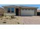 Charming single-story home featuring brick accents, a two-car garage and desert landscaping at 11744 S 173Rd Ln, Goodyear, AZ 85338