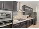 This modern kitchen features stainless steel appliances, stylish backsplash, and a gas stovetop at 11744 S 173Rd Ln, Goodyear, AZ 85338