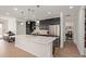 Modern kitchen with stainless steel appliances, a large island, and sleek dark cabinetry at 11744 S 173Rd Ln, Goodyear, AZ 85338