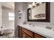 Bright bathroom featuring a vanity with solid surface counter and tub-shower combination at 1202 E Winged Foot Rd, Phoenix, AZ 85022