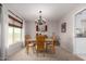 Light and airy dining room with natural light and elegant chandelier at 1202 E Winged Foot Rd, Phoenix, AZ 85022