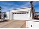 Contemporary home exterior with two-car garage and well-maintained landscaping at 1202 E Winged Foot Rd, Phoenix, AZ 85022