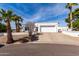 Charming front exterior of a home with a two-car garage and desert landscaping at 1202 E Winged Foot Rd, Phoenix, AZ 85022