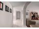 Neutral hallway with tile flooring and arched doorways leading to other rooms at 1202 E Winged Foot Rd, Phoenix, AZ 85022