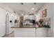 Bright kitchen featuring white cabinets, countertop seating, and modern appliances at 1202 E Winged Foot Rd, Phoenix, AZ 85022