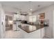 Bright kitchen with white cabinets, modern appliances, and tile flooring at 1202 E Winged Foot Rd, Phoenix, AZ 85022