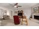 Cozy living room with neutral carpet, ceiling fan, and a stone fireplace at 1202 E Winged Foot Rd, Phoenix, AZ 85022