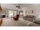 Bright and airy living room featuring neutral carpet and access to the patio at 1202 E Winged Foot Rd, Phoenix, AZ 85022