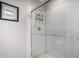 Modern walk-in shower with glass door and white tile surround at 1202 E Winged Foot Rd, Phoenix, AZ 85022