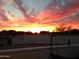 Scenic sunset featuring colorful clouds and a mountain backdrop, as seen from behind a stucco wall at 1202 E Winged Foot Rd, Phoenix, AZ 85022