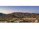 Beautiful aerial view of a shopping center with a mountain backdrop at dusk at 122 E Desert Wind Dr, Phoenix, AZ 85048