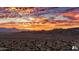 Stunning aerial view of the community homes with the desert mountains in the background and a colorful sunset sky at 122 E Desert Wind Dr, Phoenix, AZ 85048