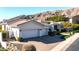 Spacious home with a three-car garage, tile roof, desert landscaping, and mountain views at 122 E Desert Wind Dr, Phoenix, AZ 85048