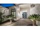 Close-up of the front entrance, showcasing a stylish door, decorative plants, and a paved walkway at 122 E Desert Wind Dr, Phoenix, AZ 85048