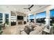 Modern living room featuring a stone fireplace and seamless indoor-outdoor living with a large sliding door at 122 E Desert Wind Dr, Phoenix, AZ 85048