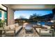 Relaxing outdoor patio with comfortable seating, a bar, and a serene view of the pool and mountains at 122 E Desert Wind Dr, Phoenix, AZ 85048