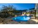 Sparkling pool and spa area with lush landscaping and elegant lighting for evening enjoyment at 122 E Desert Wind Dr, Phoenix, AZ 85048