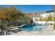 Backyard pool area with mountain views, lounge chairs, and lush desert landscaping at 122 E Desert Wind Dr, Phoenix, AZ 85048